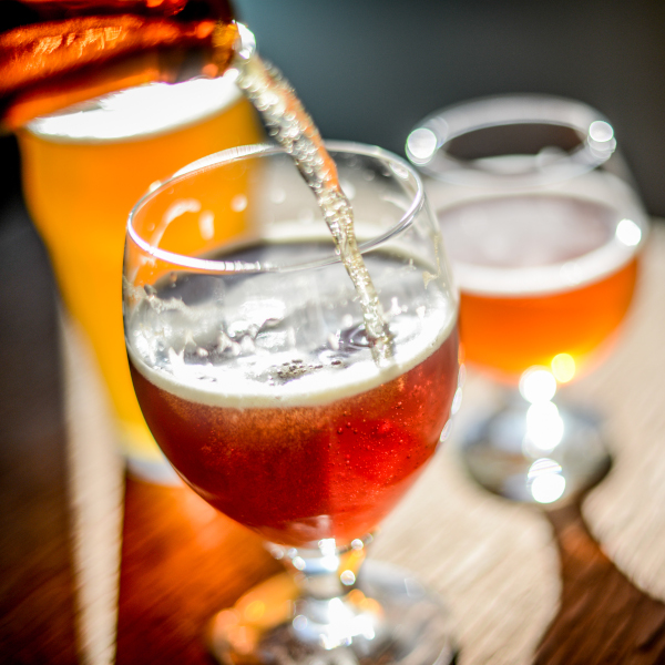amber ale being poured into a beer glass