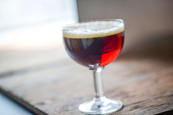 brown red beer in stemmed glass