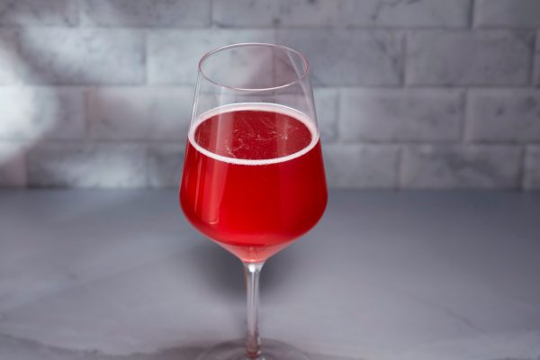 red-colored sparkling wine or beer