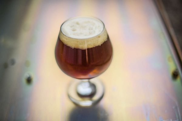 amber brown beer in small snifter glass