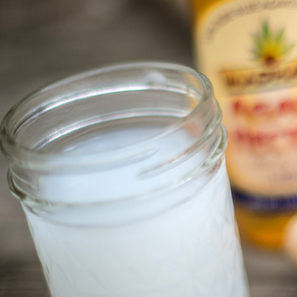 A glass of white-colored pulque