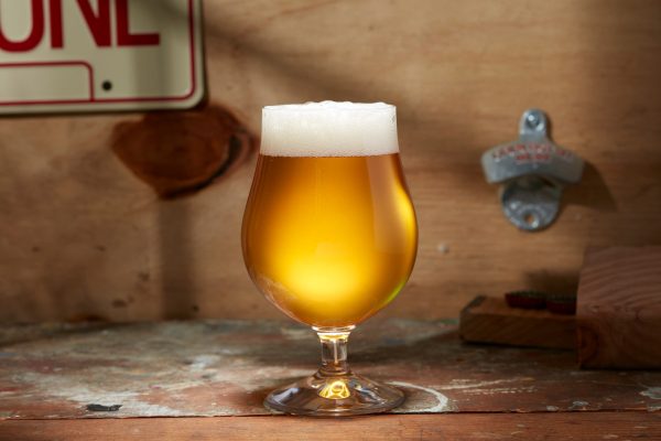 gold color beer in stemmed glass