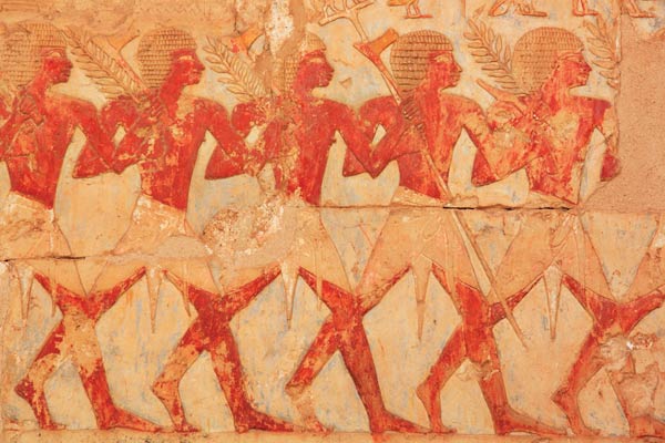 Ancient Egyptian art depicting people carrying grains
