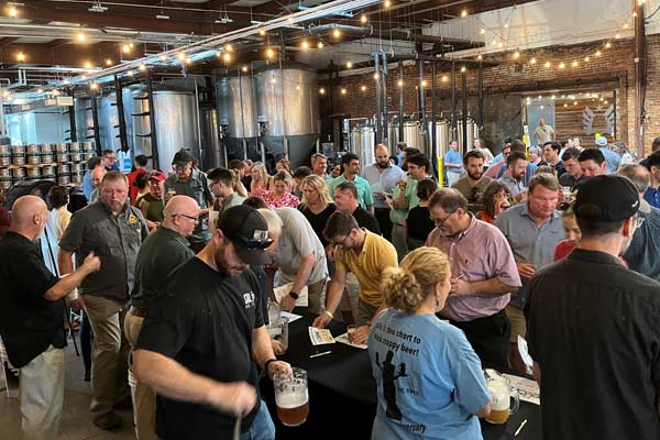Folks arrending a homebrew event in a brewery setting