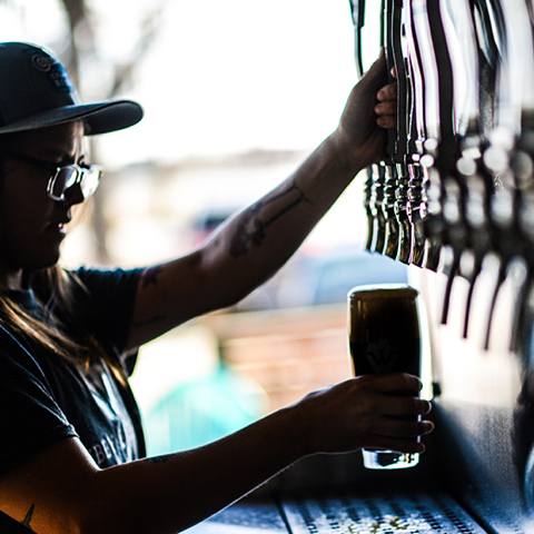 Fresh draught beer poured by a woman
