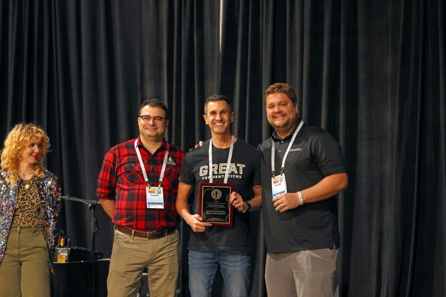 Great Fermentations accepting an award on stage.