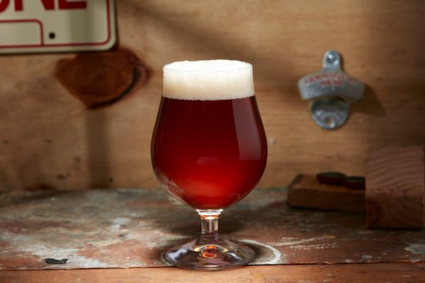 red-brown beer in stemmed glassware